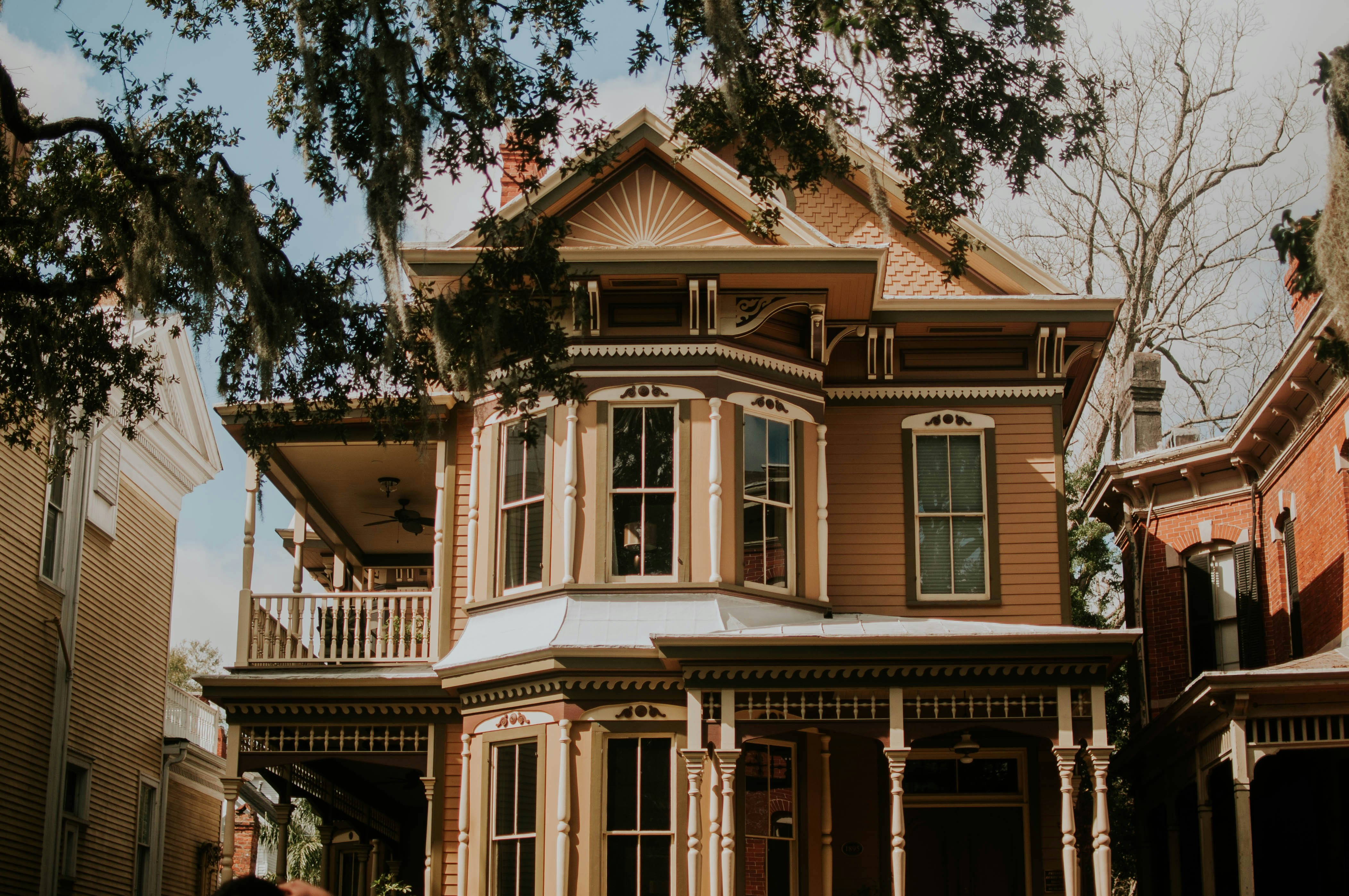 a large house with a tree in the front