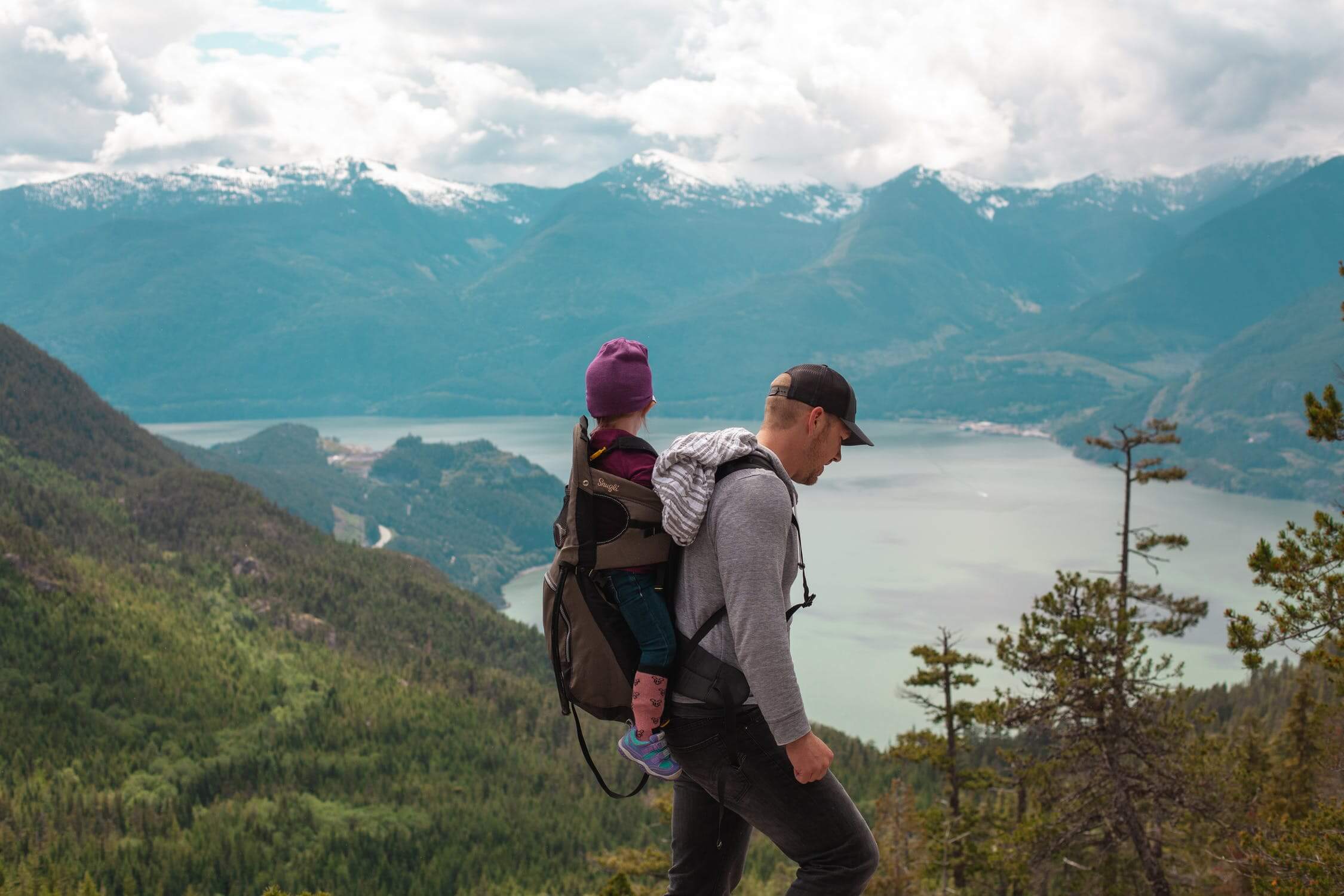 a man and woman walking on a mountain top