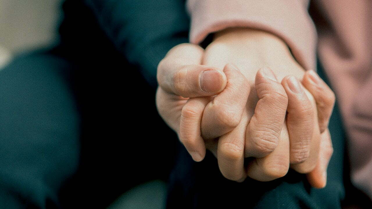 close-up of a person holding the hands together
