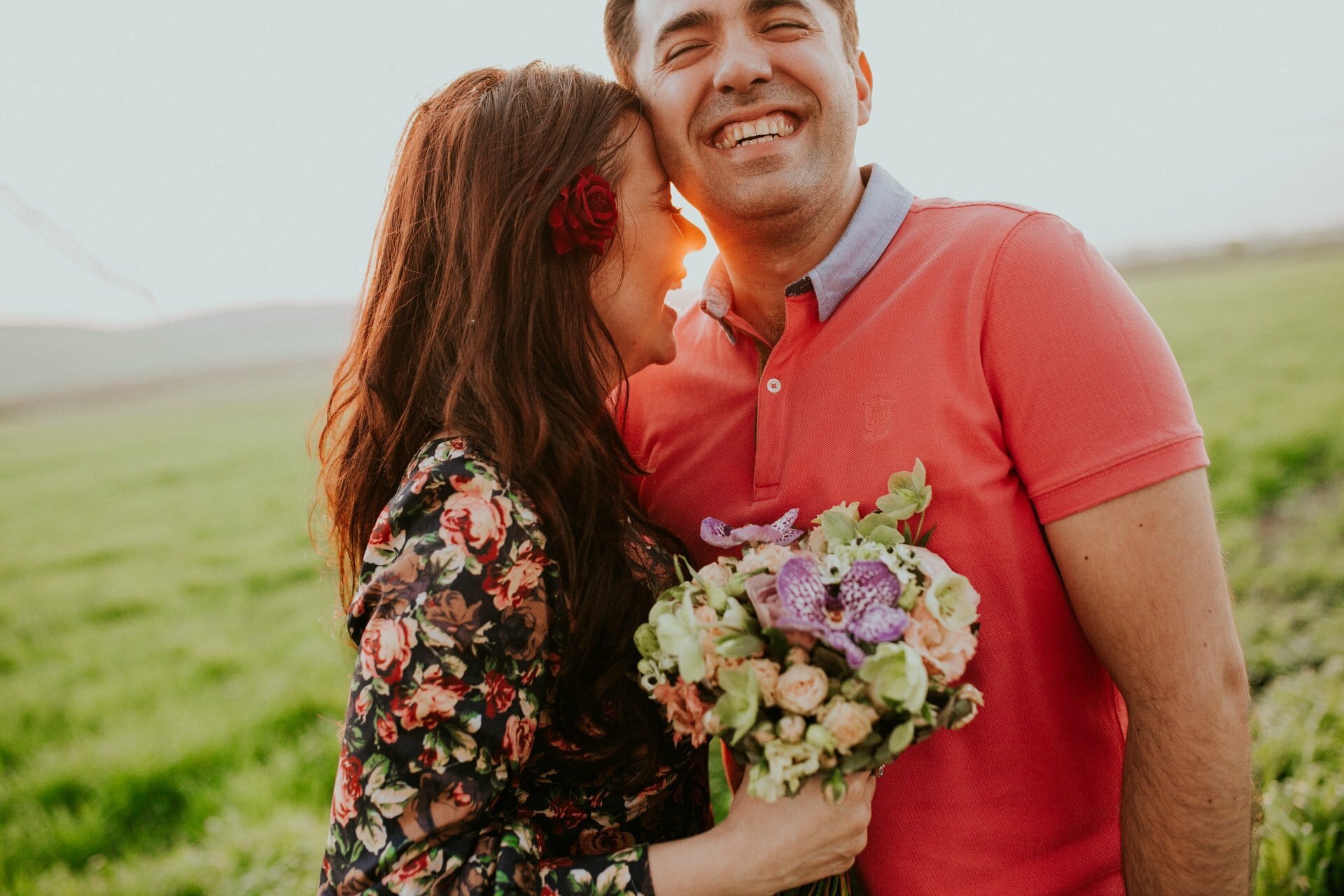 a man and woman holding flowers