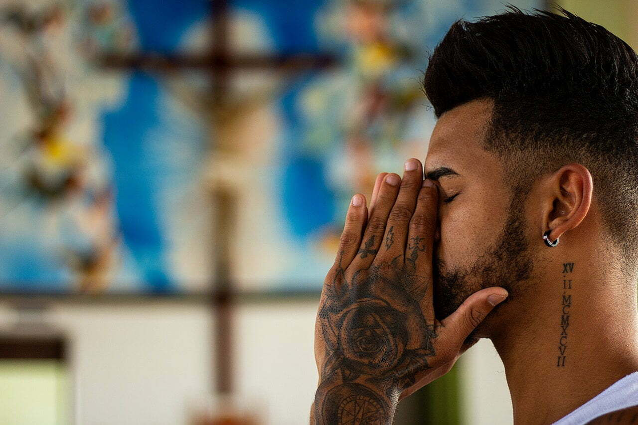 a man with his hand on his face
