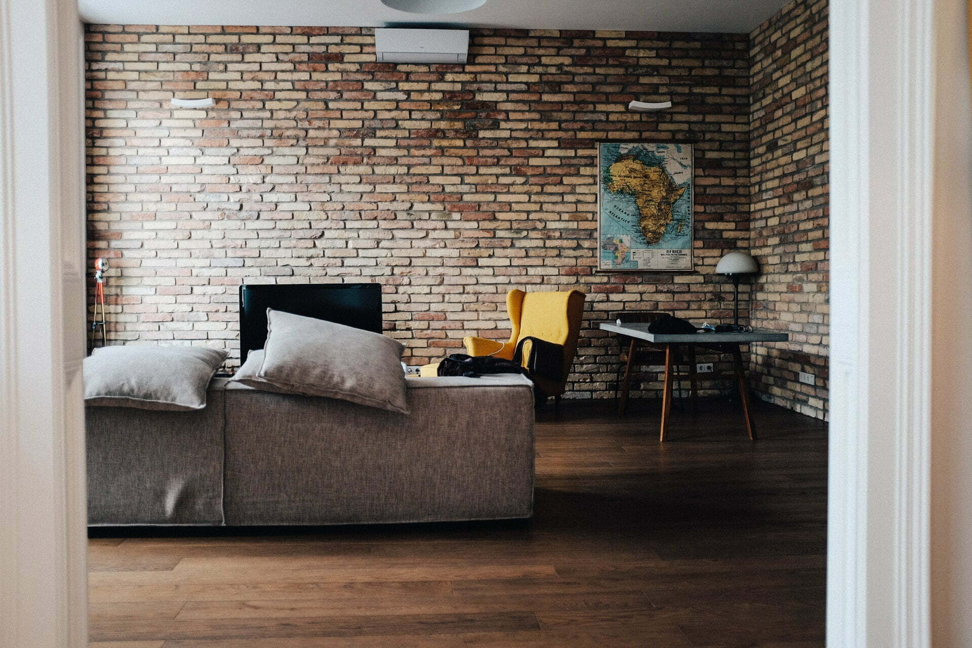 a living room with a brick wall