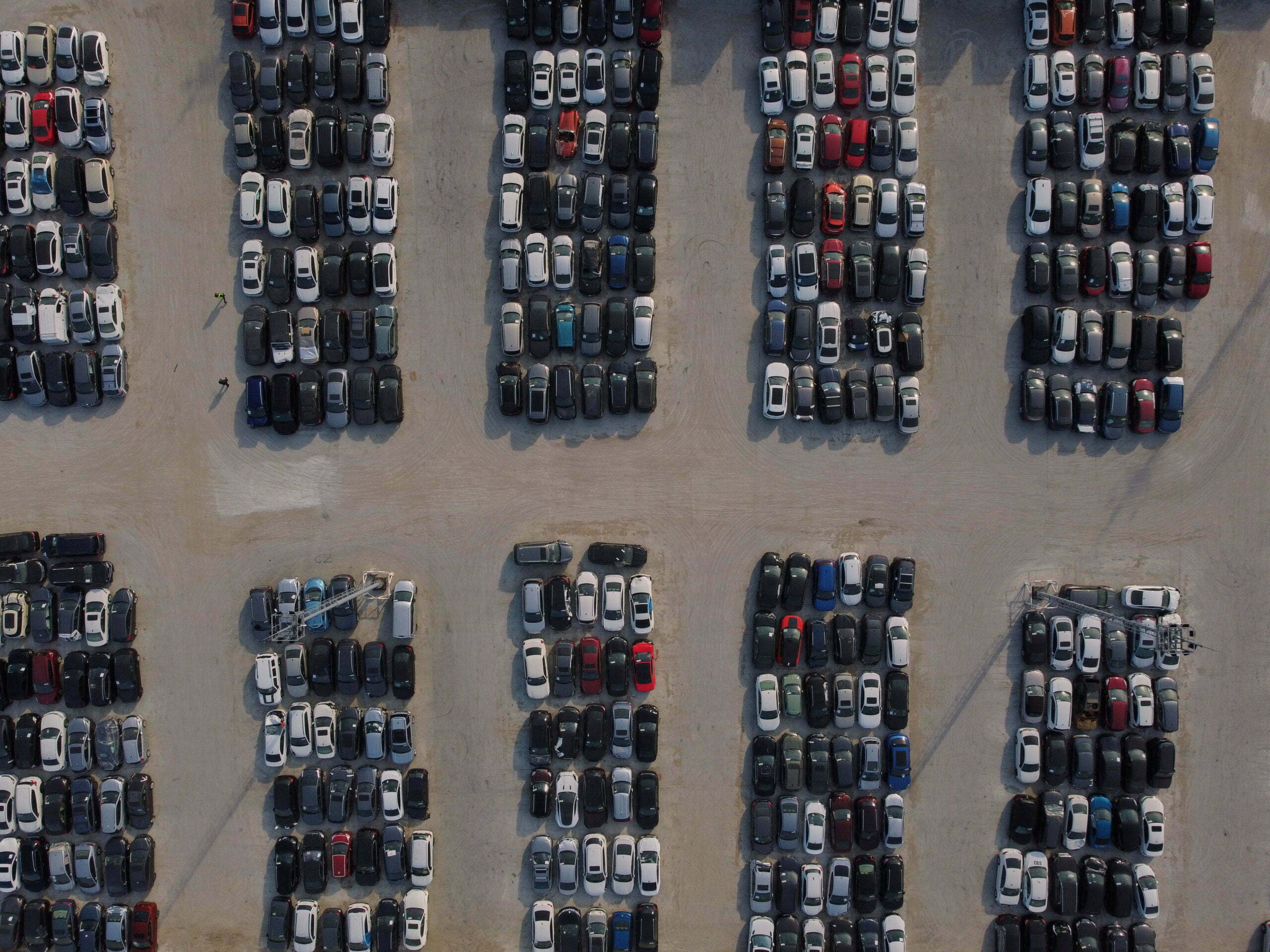 Aerial view of used wrecked automobile storage lot parking