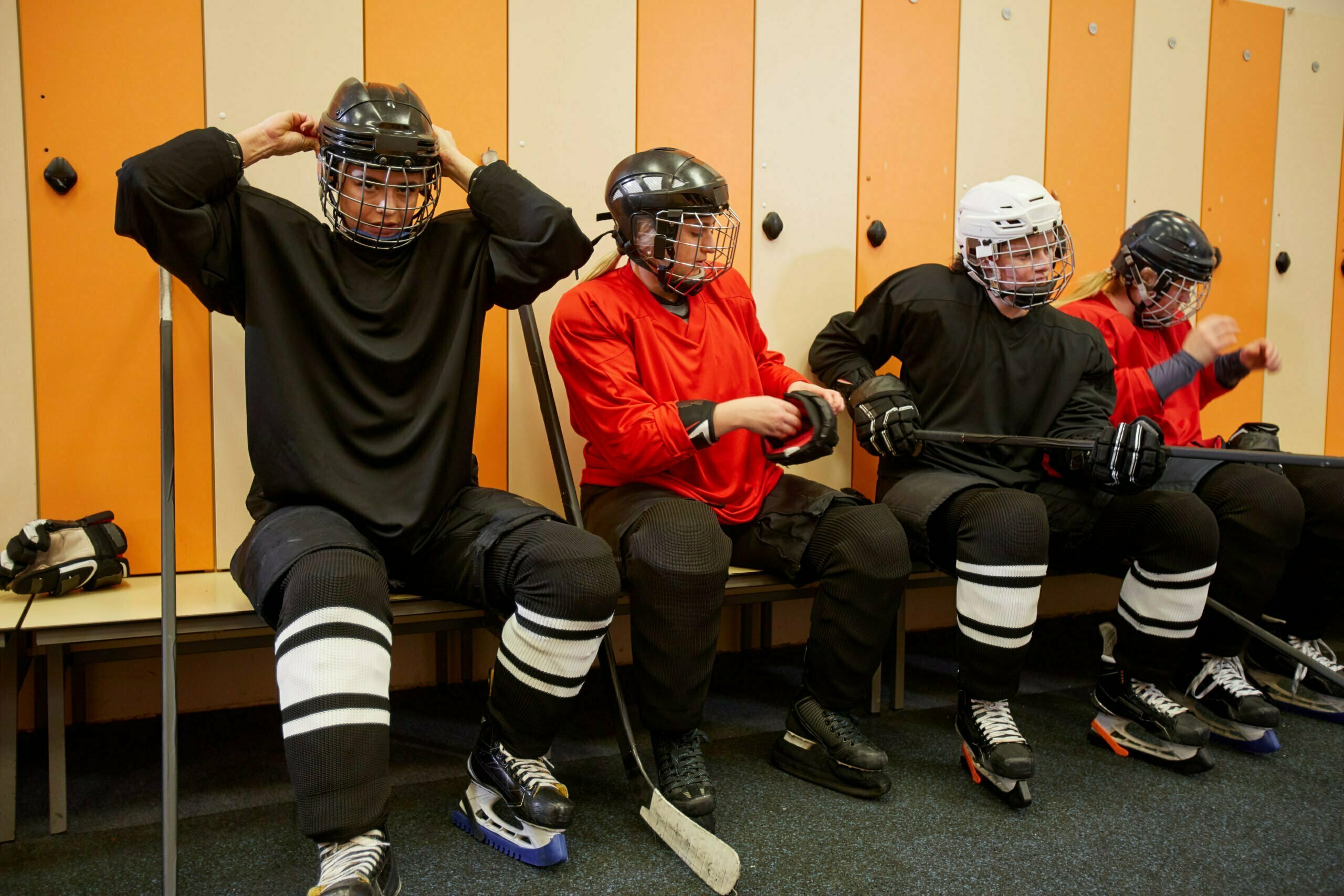 Female Hockey Team Getting Ready in Locker Room